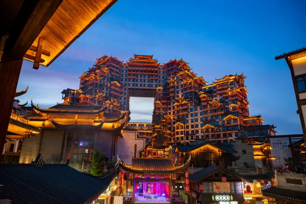Zhangjiajie 72 Wonder Tower light show time with evening lights, traditional rooftops and cultural night atmosphere