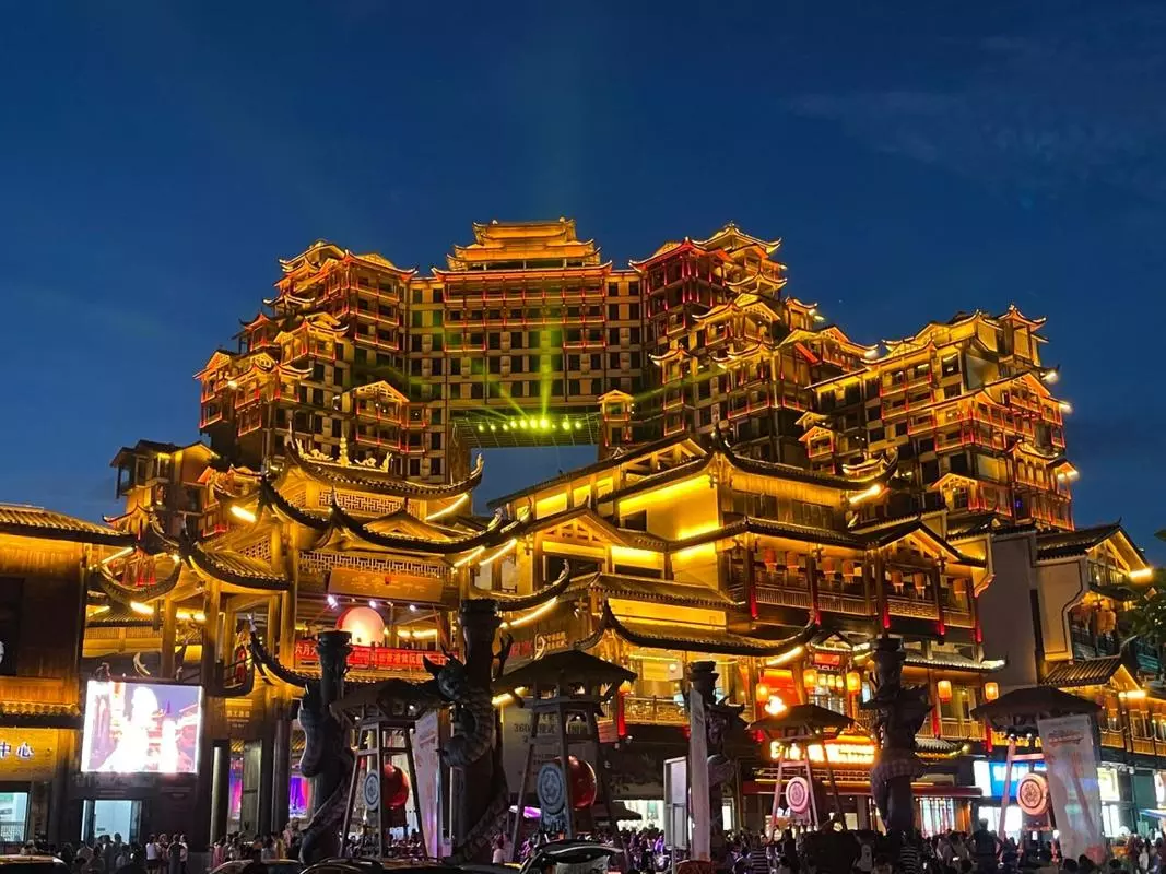 72 Wonder Tower Zhangjiajie evening street view with visitors and illuminated buildings