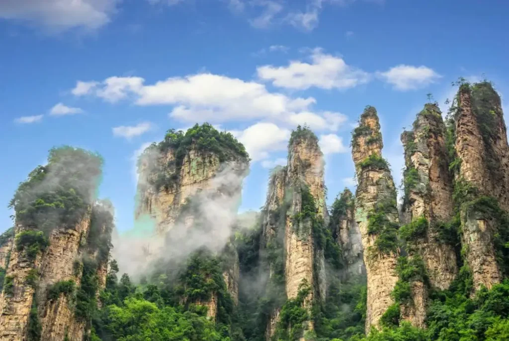 avatar mountains china real sandstone pillars in Zhangjiajie National Forest Park with mist and blue sky