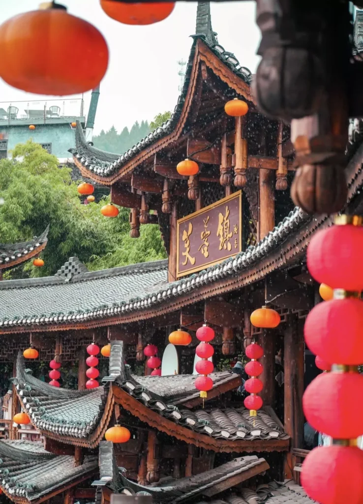 Furong Ancient Town traditional wooden roofs and red lanterns on a rainy day
