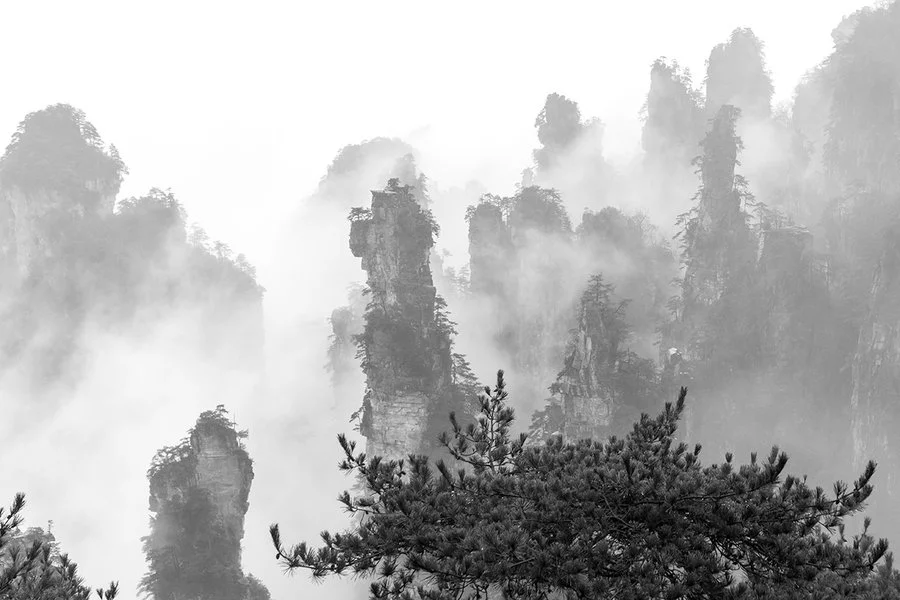 weather for zhangjiajie with foggy mountain peaks and cloudy scenic views after rain