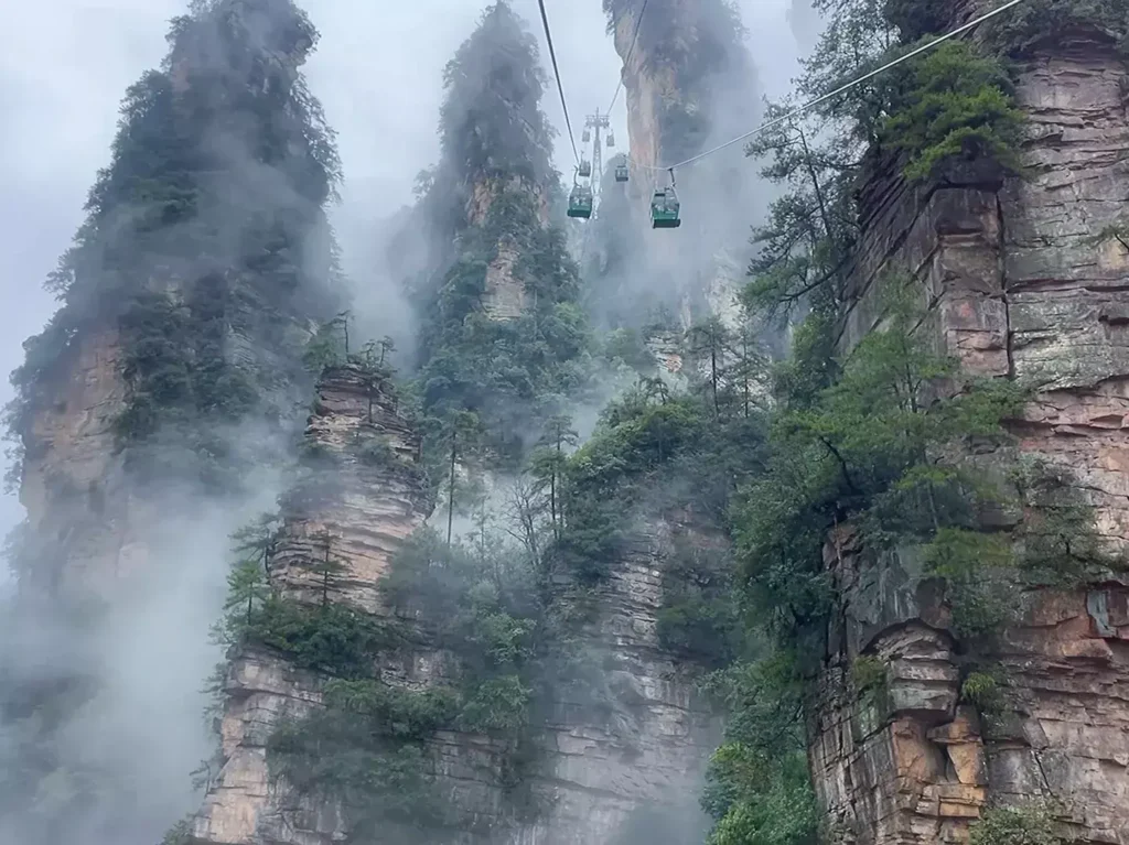weather for zhangjiajie with misty sandstone peaks and cable cars in Zhangjiajie National Forest Park