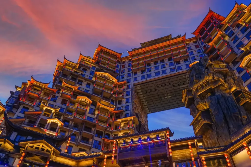 Zhangjiajie 72 Wonder Tower light show time close-up with colorful sunset sky and illuminated tower details