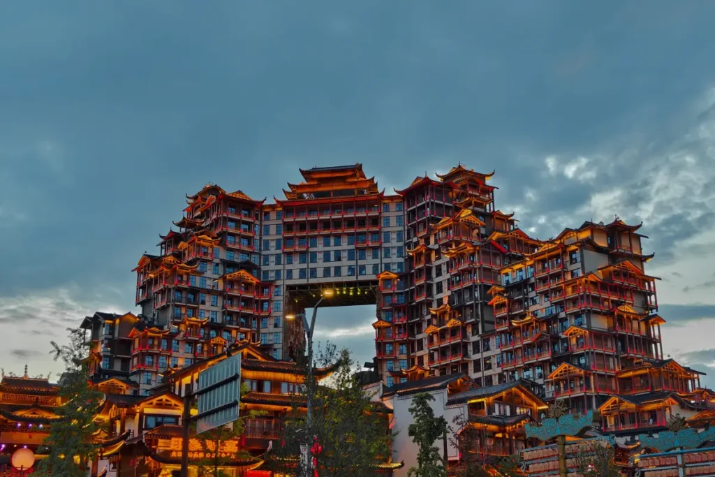 Zhangjiajie 72 Wonder Tower light show time during dusk with illuminated building and cloudy evening sky