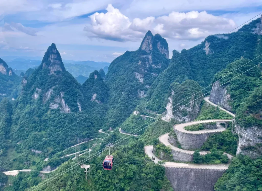 zhangjiajie mountains with tall sandstone pillars, forest-covered cliffs and misty valley scenery