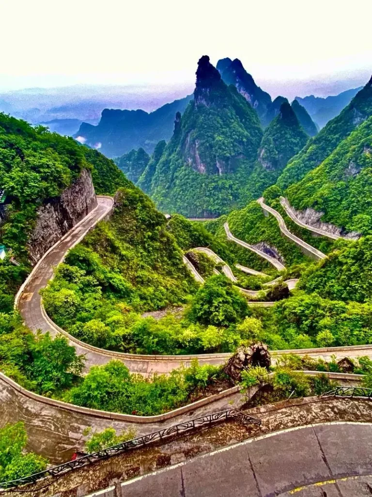 Zhangjiajie Tianmen Mountain 99 bends road through green mountain scenery