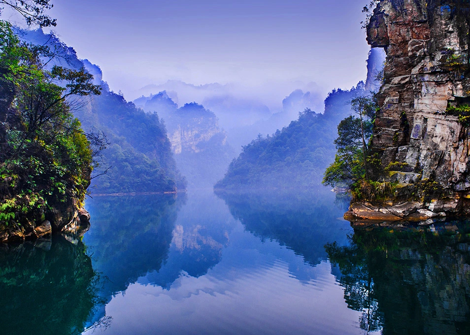 zhangjiajie china Baofeng Lake with calm water and misty mountain reflections