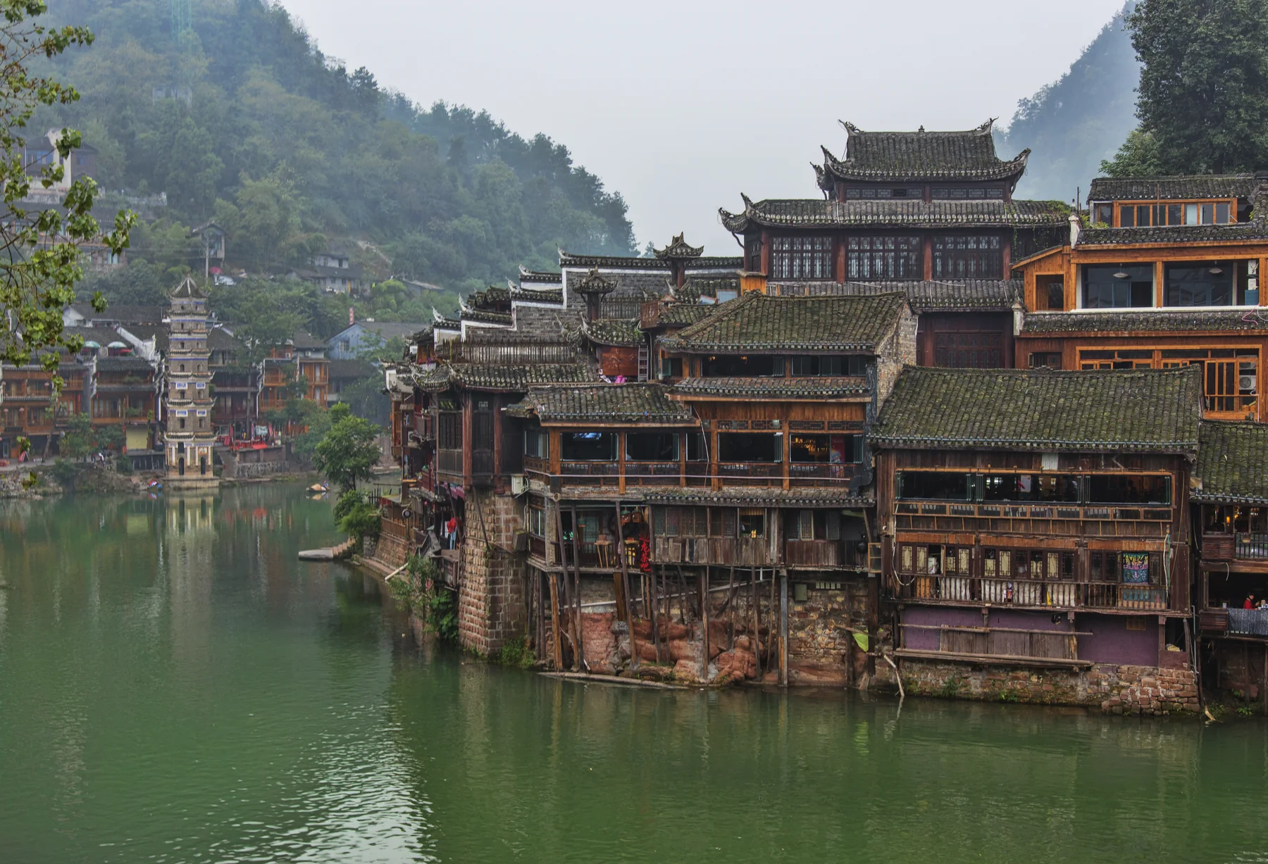 zhangjiajie to fenghuang ancient town riverside arrival view with wooden houses and Tuojiang River