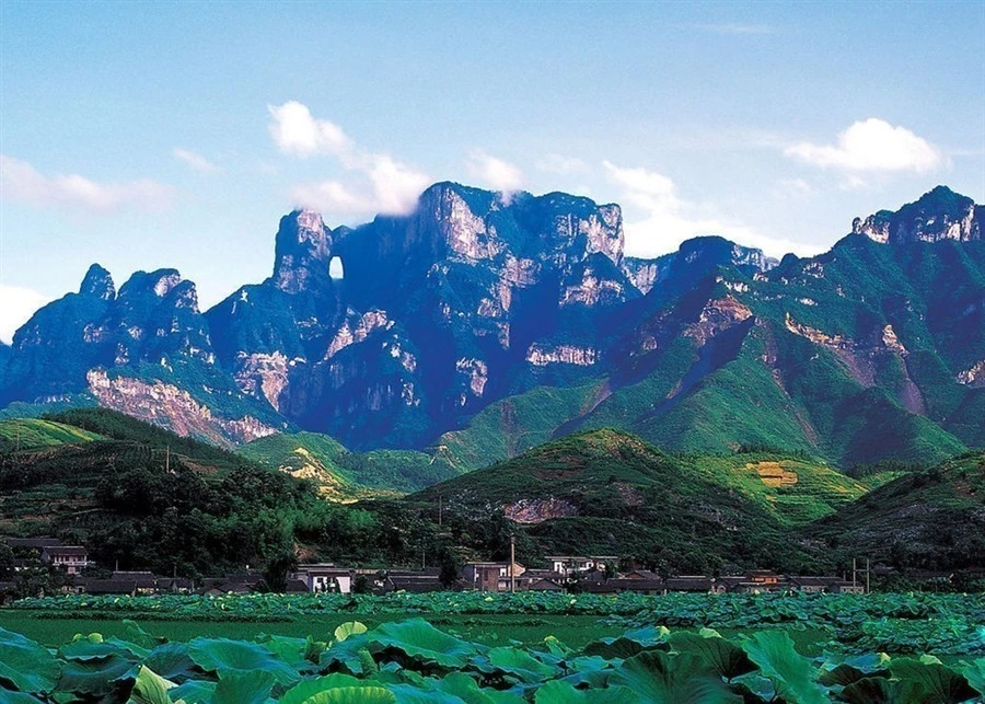 zhangjiajie wulingyuan mountain landscape with green fields and distant peaks