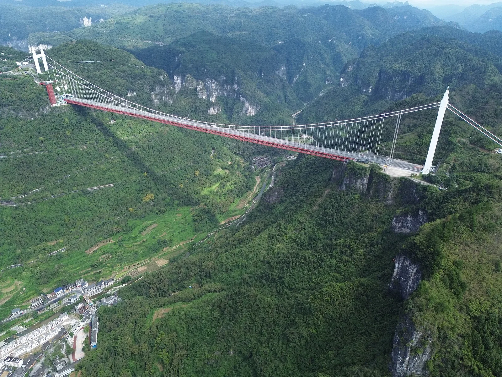 aizhai bridge viewpoint showing the bridge structure across a green canyon