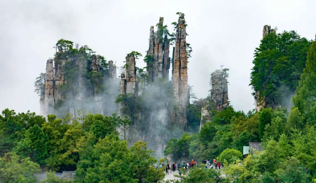 tianzi mountain forest peaks with visitors walking below the sandstone cliffs in Zhangjiajie