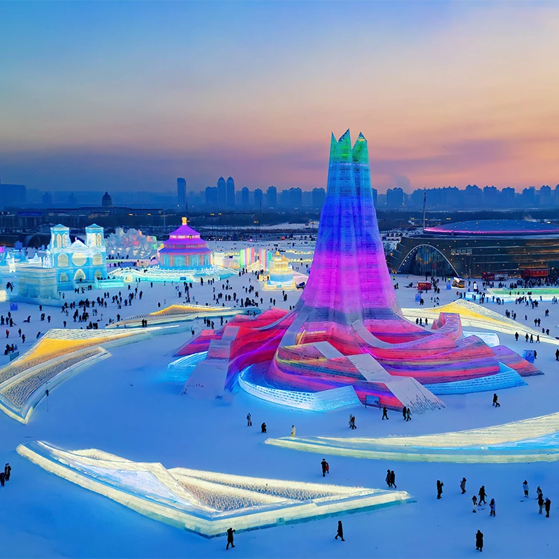 Illuminated ice palaces at Harbin Ice and Snow World at night