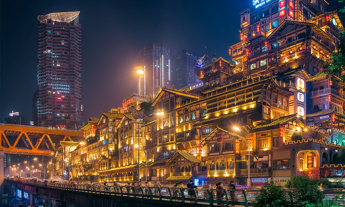 Brightly illuminated riverside buildings in Chongqing at night