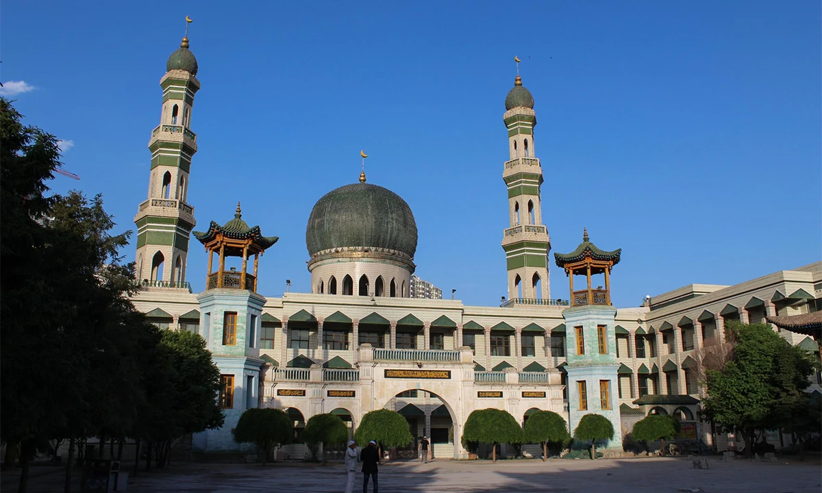 Mosque with green domes and minarets beneath a blue sky in Xining