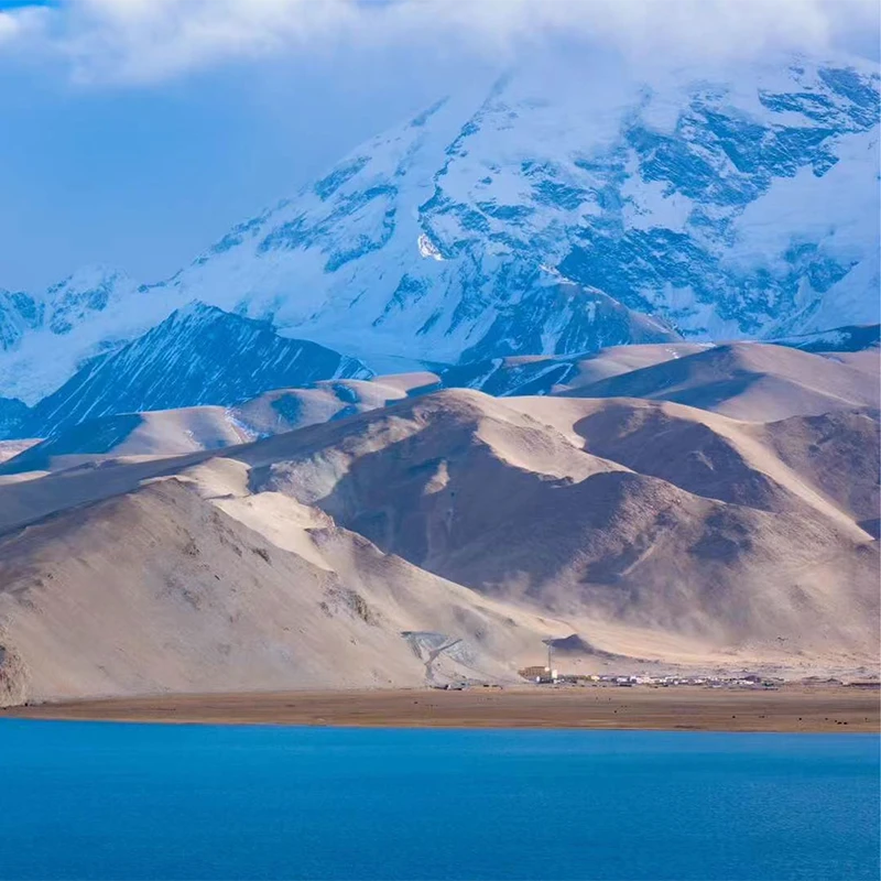 Karakul Lake reflecting Muztagh Ata on the Karakoram Highway