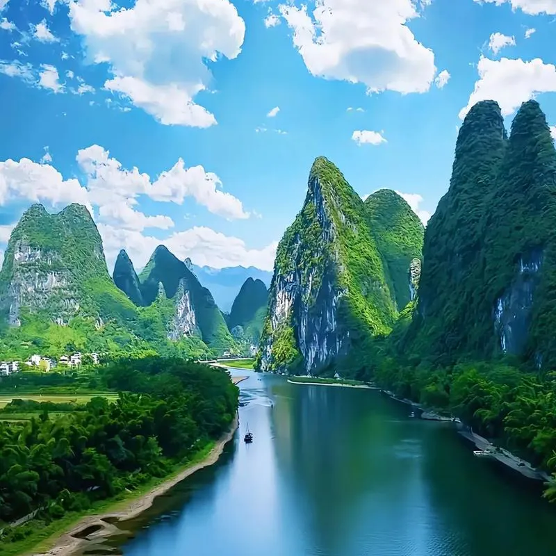 Li River cruise boat passing karst peaks between Guilin and Yangshuo