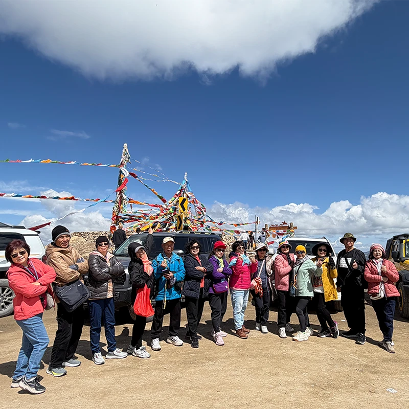 Muslim group tour at a mountain pass on the Karakoram Highway near Kashgar