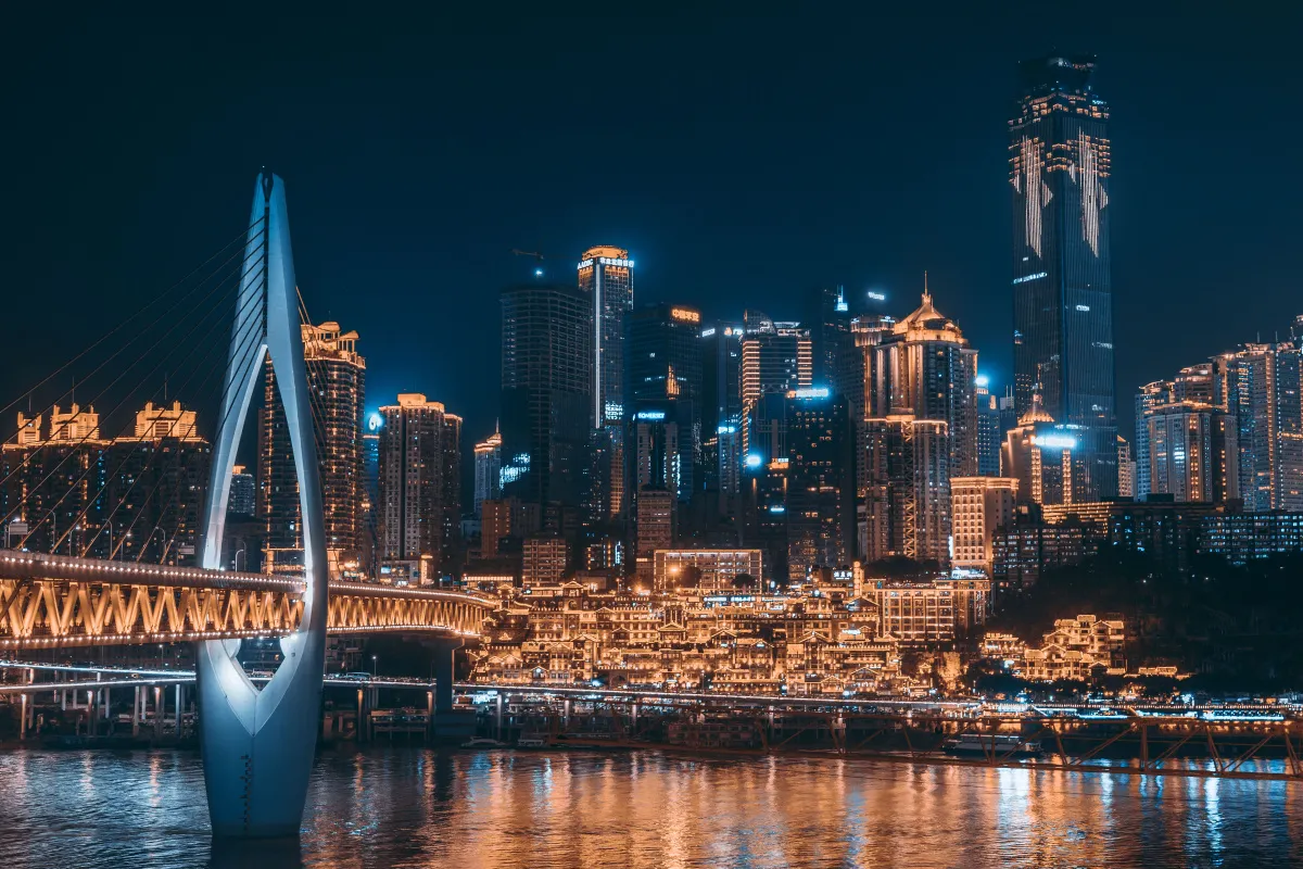 Chongqing night skyline across the Jialing River with Qiansimen Bridge and Hongyadong lit up