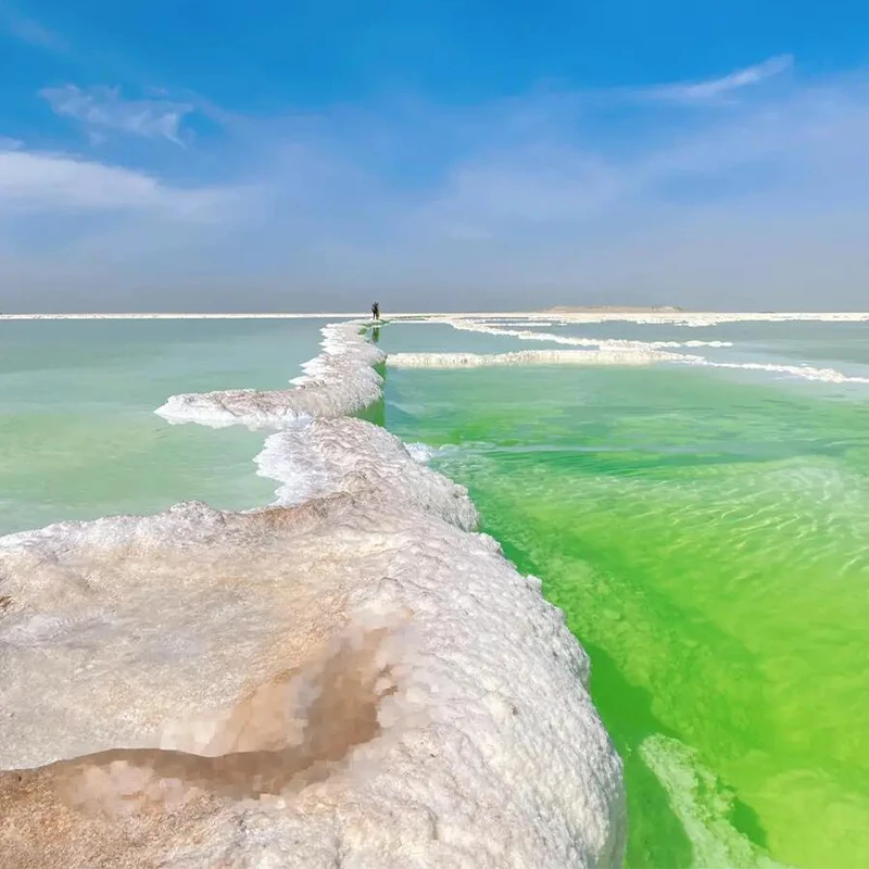 White salt flats and turquoise water at the Xinjiang Salt Lake scenic area near Urumqi