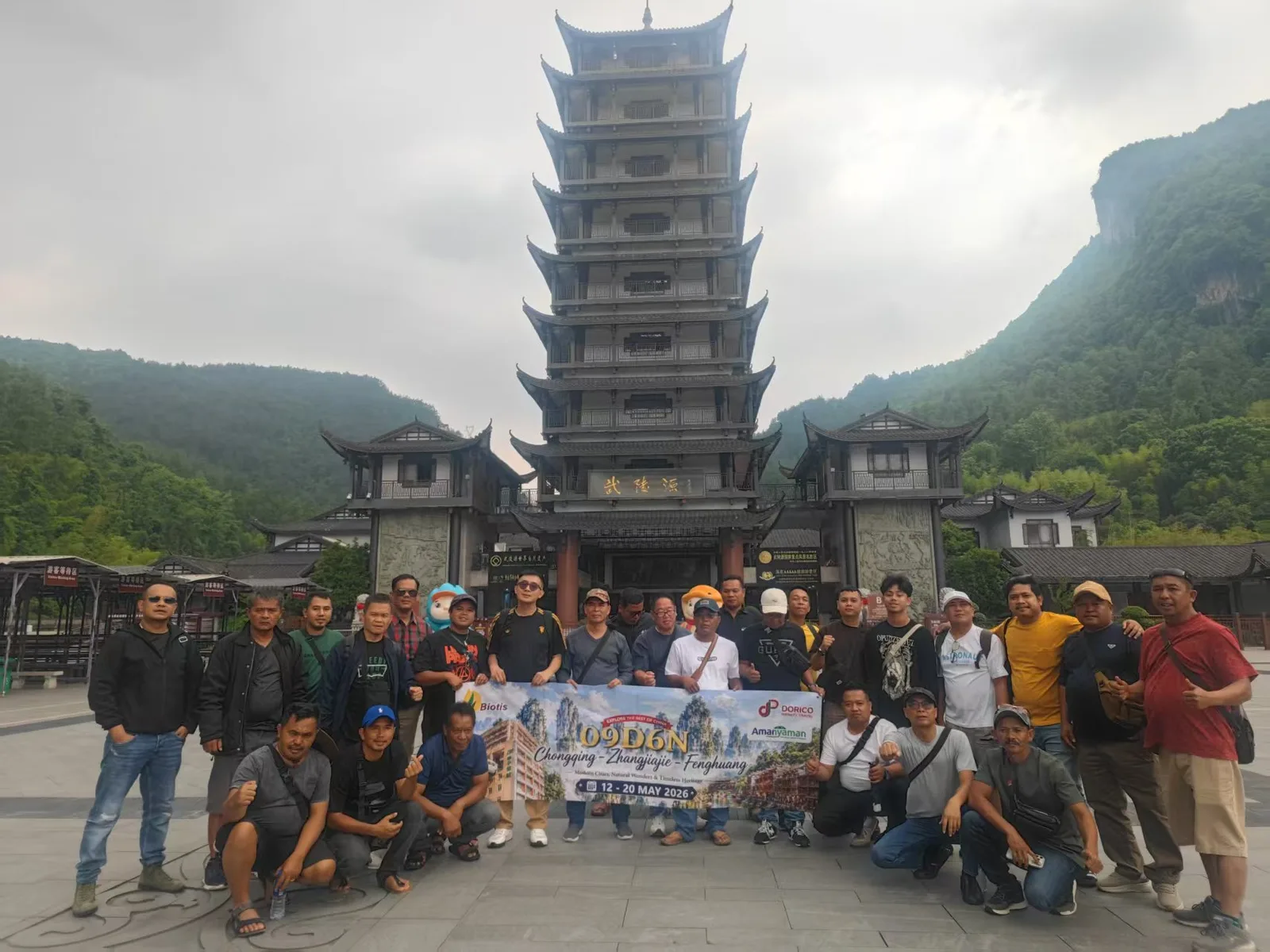 Large Muslim tour group posing at the Wulingyuan gate tower in Zhangjiajie
