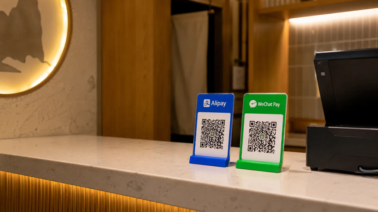 Alipay and WeChat Pay QR payment stands on a restaurant counter in China