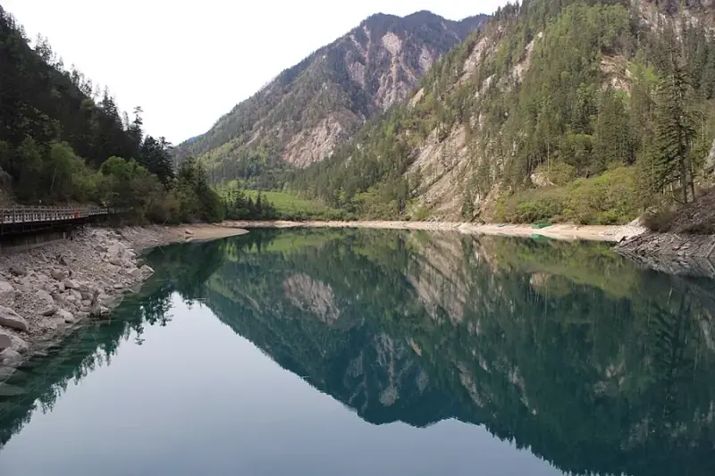 Turquoise lake ringed by forest in Jiuzhaigou National Park