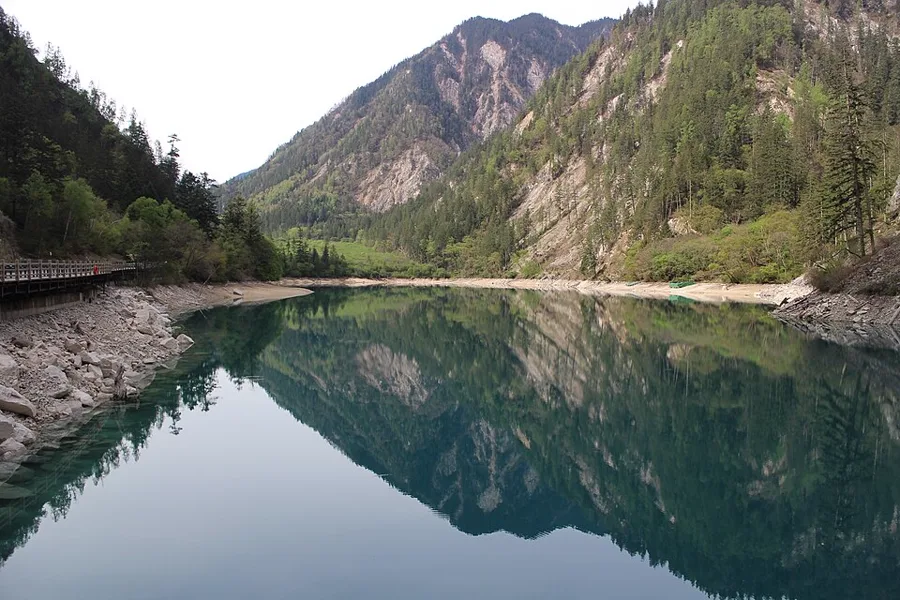 Turquoise lake ringed by forest in Jiuzhaigou National Park