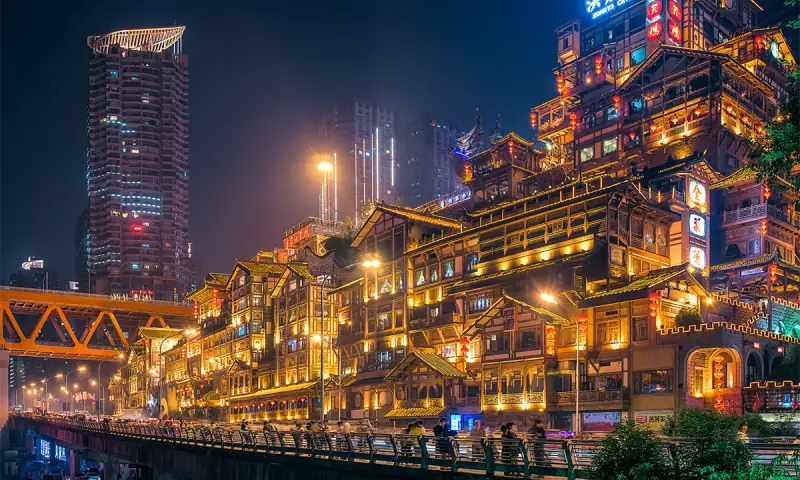 Brightly illuminated riverside buildings in Chongqing at night