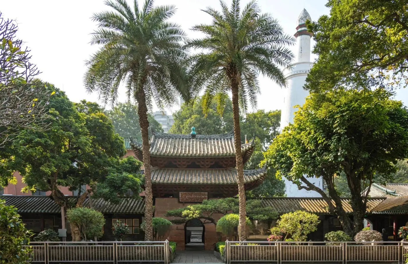Courtyard of Huaisheng Mosque in Guangzhou with its white minaret rising behind the trees