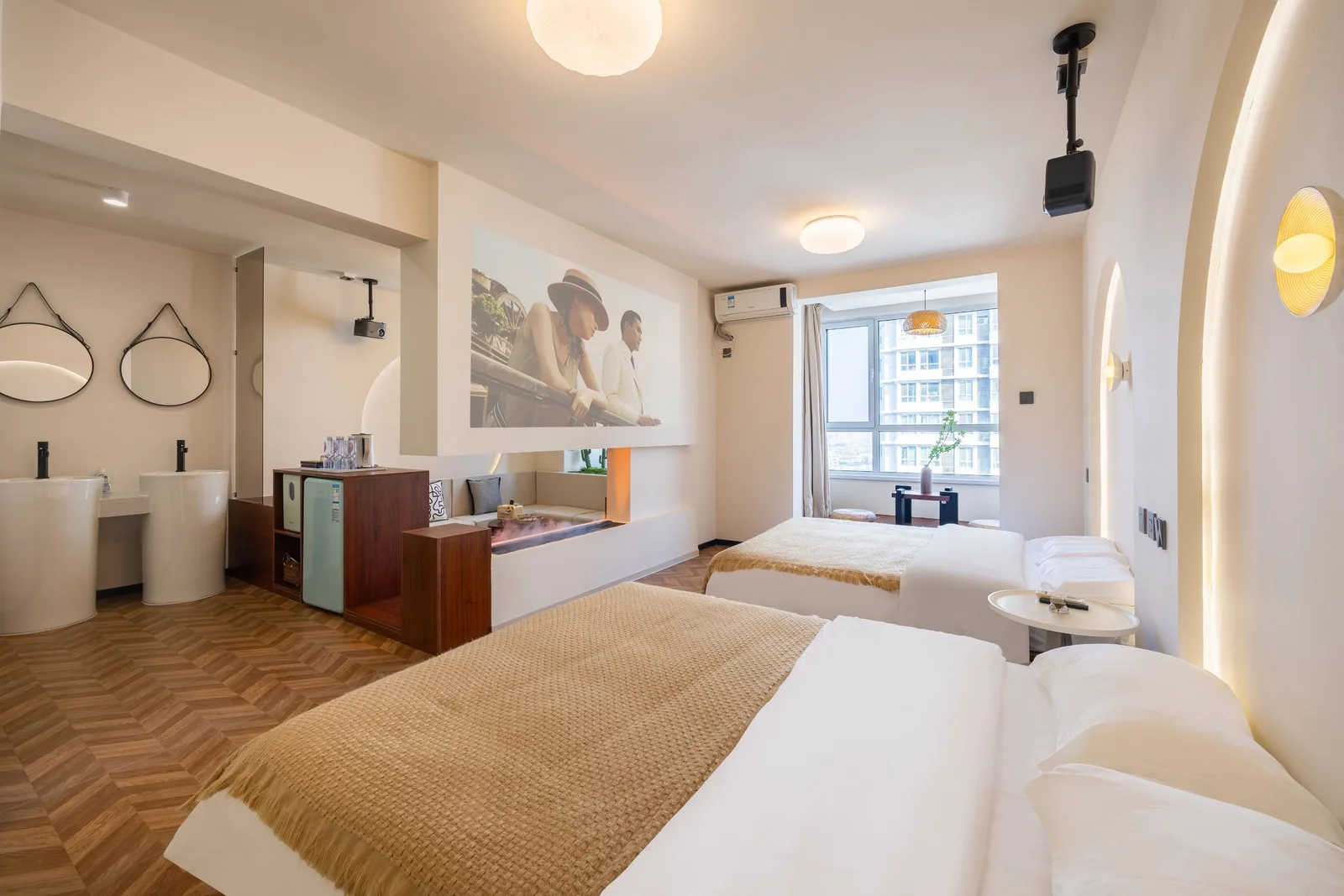 Family room in a Chinese hotel with two wide beds, twin washbasins and a bay window seating area
