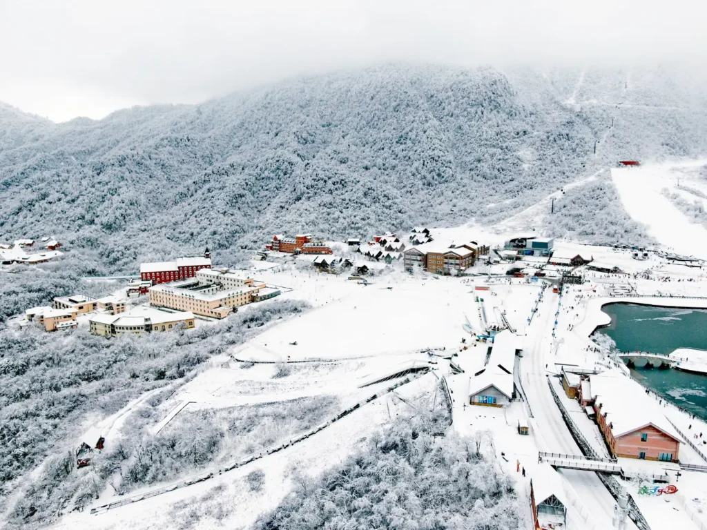 Snow-covered resort village and ski slopes at Xiling Snow Mountain near Chengdu in deep winter